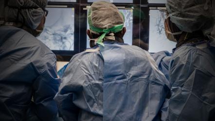 Surgeons from behind operating