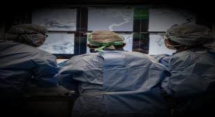 Surgeons from behind operating
