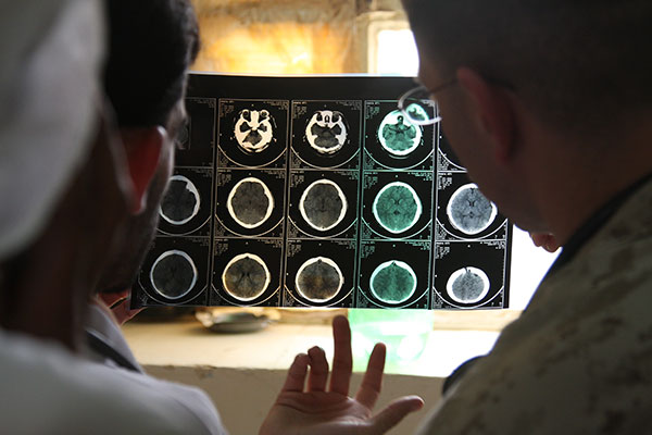 Military doctors review a CAT scan at a clinic in Iraq. (DoD photo by Sgt. Christopher Giannetti)