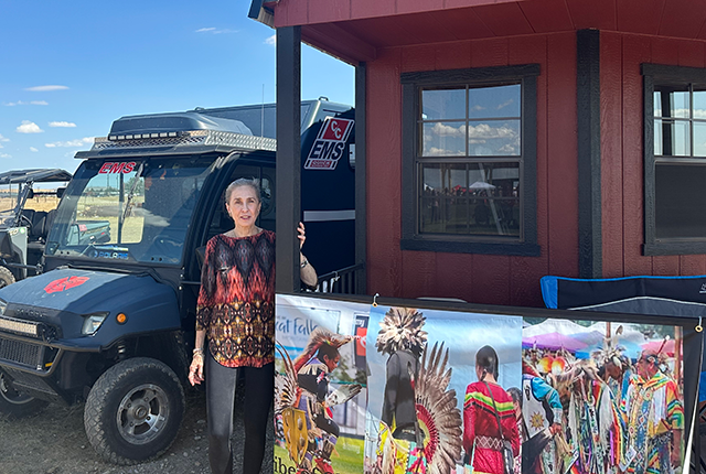 Woman in front of house and truck