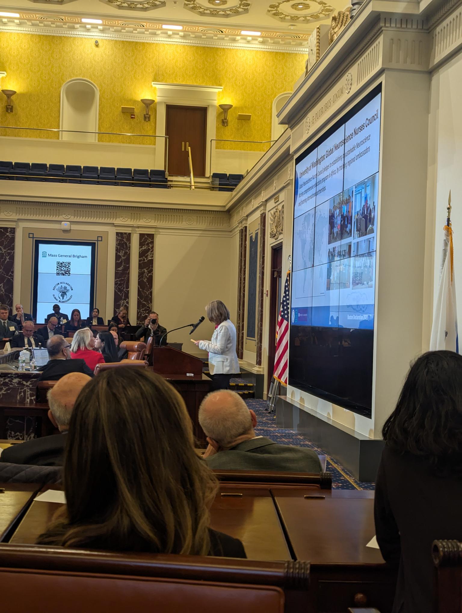 The Boston Declaration on Global Neurosurgery: A Renewed Global Commitment to Advance Neurosurgical Care for All. Lecture on a projector with people in the room