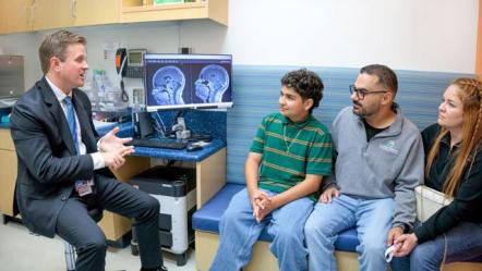 Photo of Doctor sitting with patients 