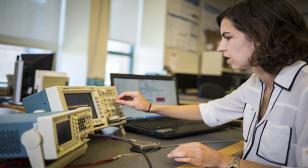 UW electrical engineering doctoral candidate and CSNE team member Margaret Thompson performs laboratory tests on a Medtronic deep brain stimulator to verify that the new closed-loop system for essential tremor functions as intended. Mark Stone/University of Washington