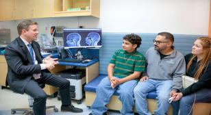 Photo of Doctor sitting with patients 